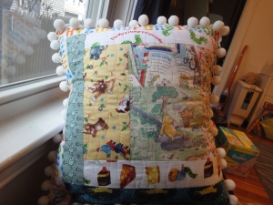 Pillow made with fabric printed with characters and letters from children's books