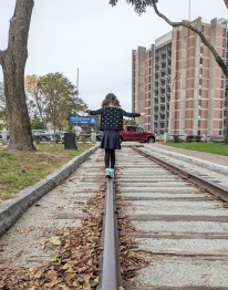 Girl balancing on train track